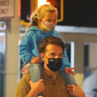 Bradley Cooper and his daughter Leah walk through the night city
