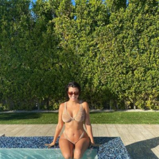 Kourtney Kardashian tried on a revealing mini bikini by the pool 